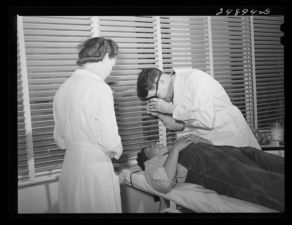 Doctor examining patient. Robstown FSA (Farm Security Administration) camp, Texas. Sourced from the Library of Congress.
