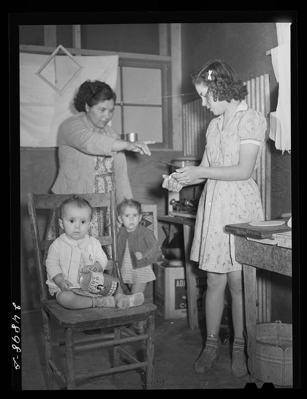 [Untitled photo, possibly related to: Family preparing tortillas for supper. Robstown camp, Texas]. Sourced from the Library…