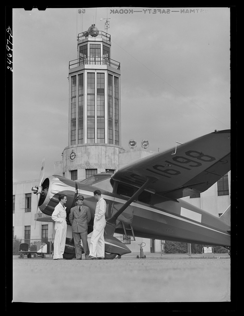 [Untitled photo, possibly related to: Fort Worth, Texas. Meacham Field. Instructor and students, control tower in…