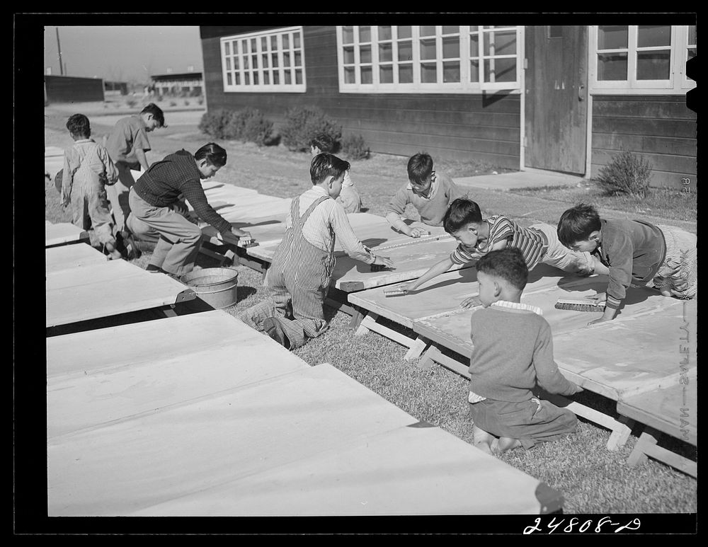 Older boys wash nursery school cots on Saturday morning. Robstown, Texas. Sourced from the Library of Congress.
