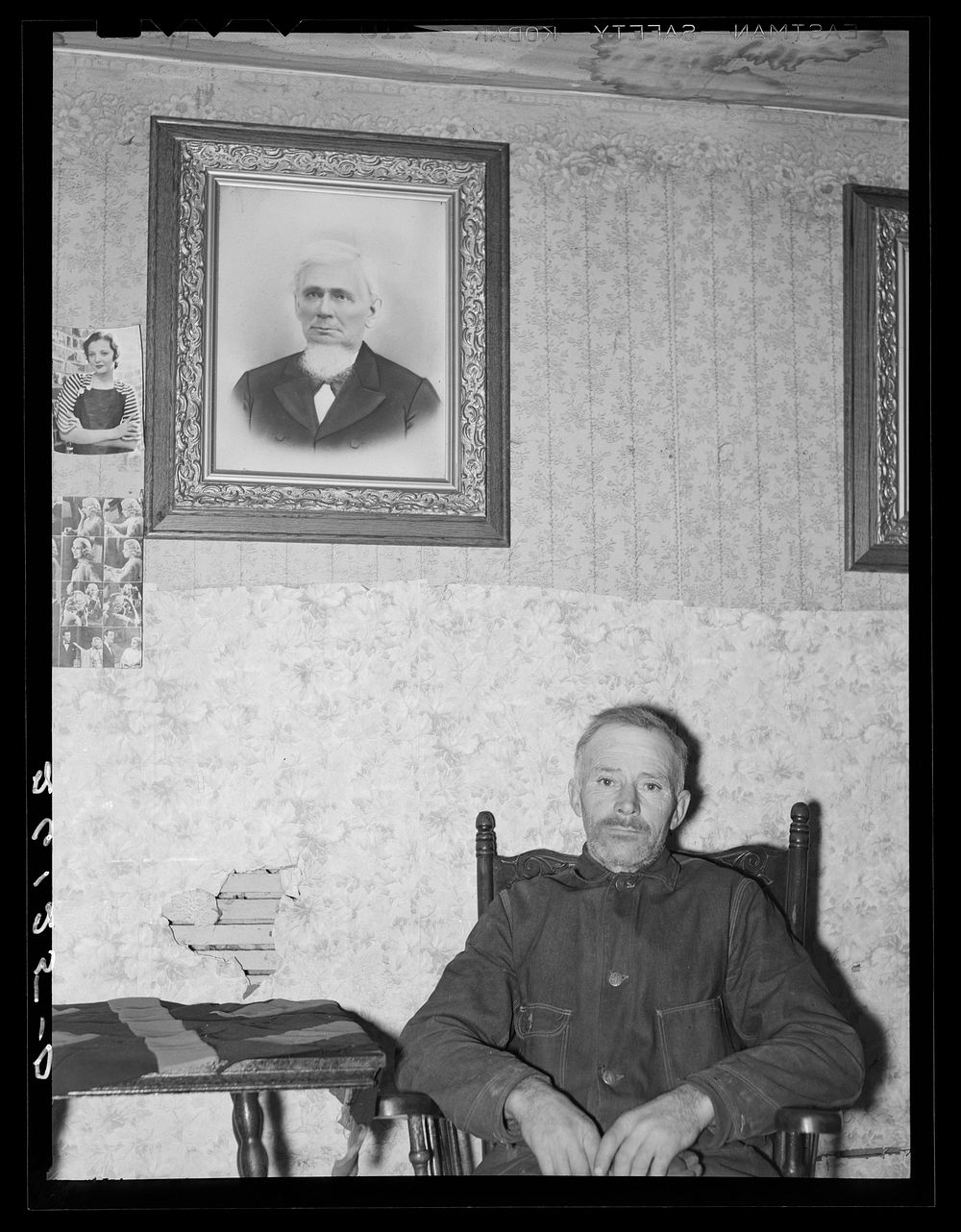 Fred Gleason with portrait of his father. Belfast, New York, Allegany County. Sourced from the Library of Congress.
