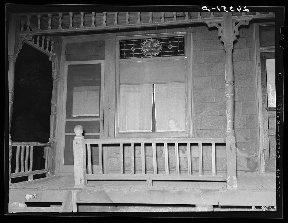 Prostitute at window. Peoria, Illinois. Sourced from the Library of Congress.