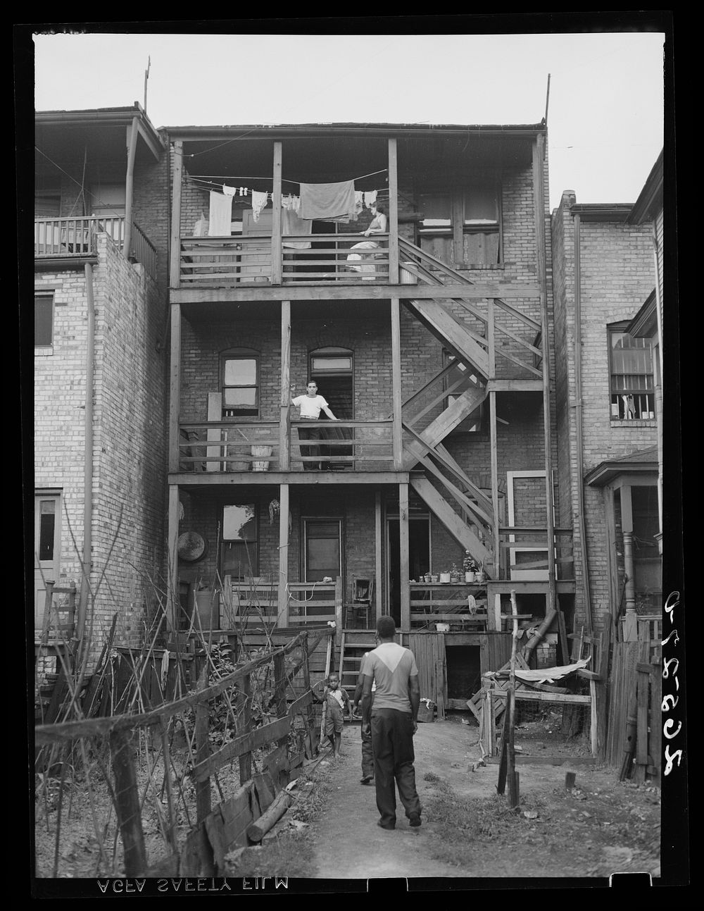 Slum tenant house in which both  and white families live. Midland, Pennsylvania. Sourced from the Library of Congress.