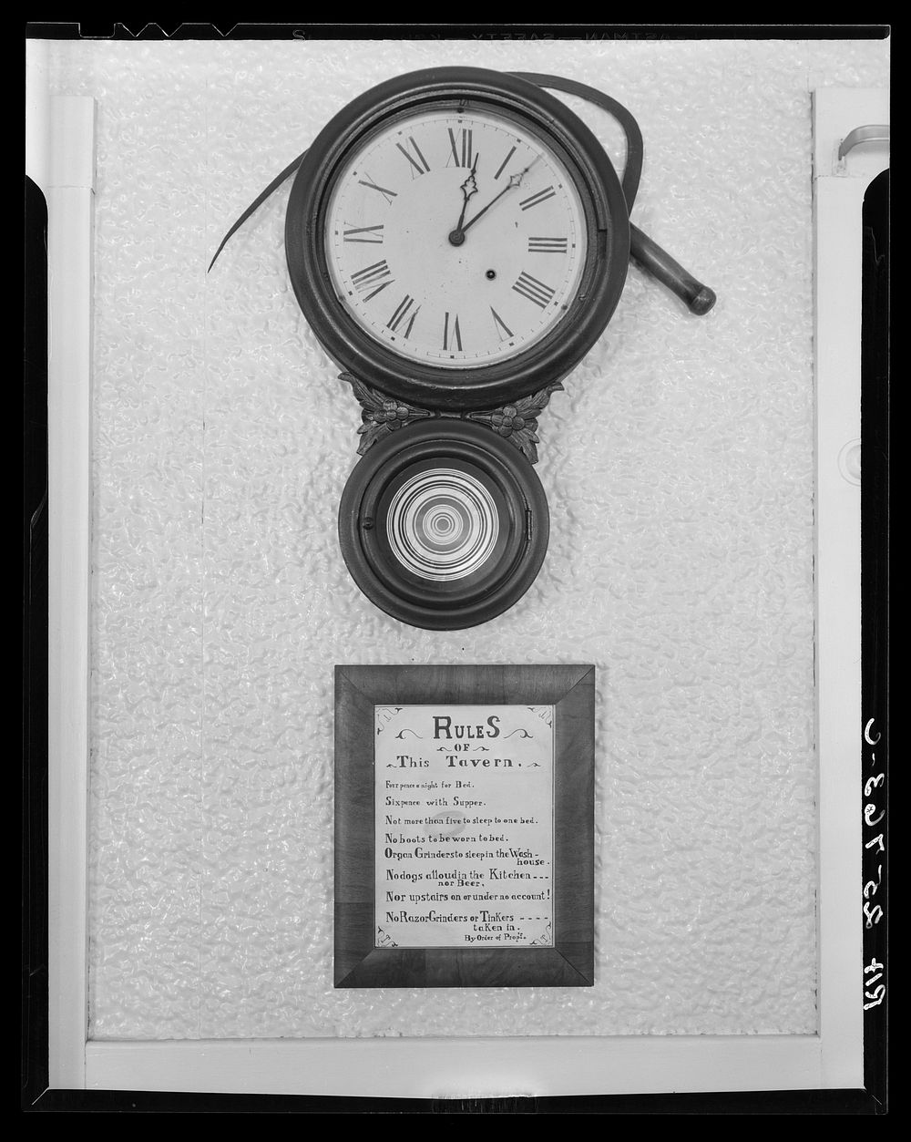 Clock and sign in tavern. Smuggler's Notch, Vermont. Sourced from the Library of Congress.