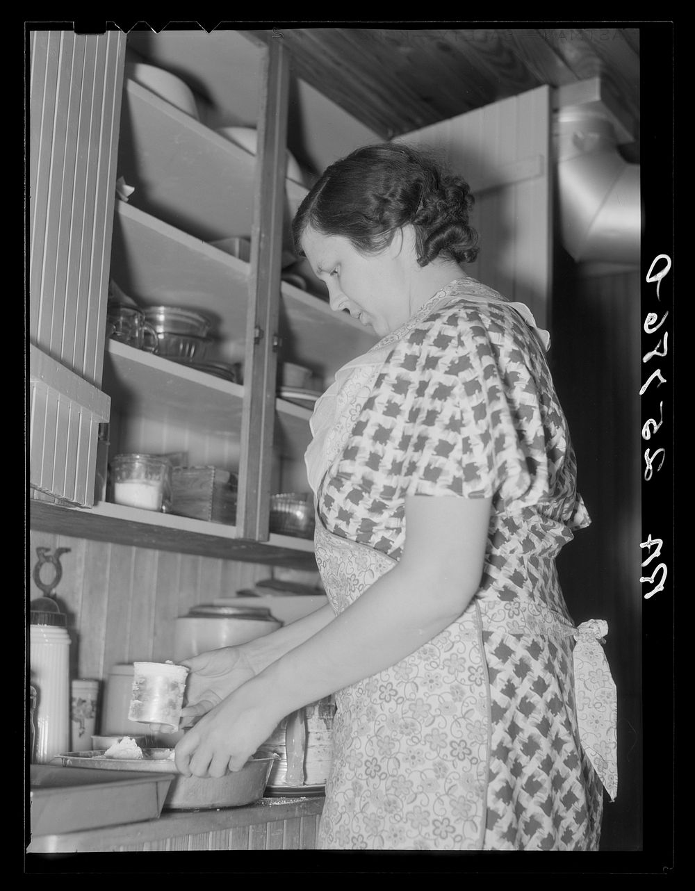 Mrs. McNally baking a cake for dinner. Kirby, Vermont. Sourced from the Library of Congress.