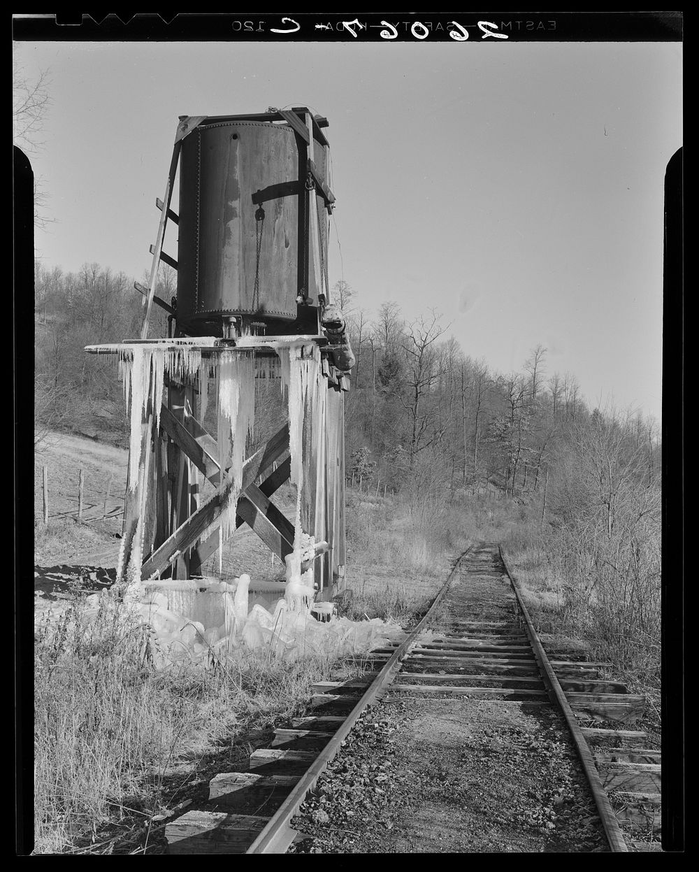 Water tower on railroad through Jennings, Maryland. The train now runs only once a week. Sourced from the Library of…