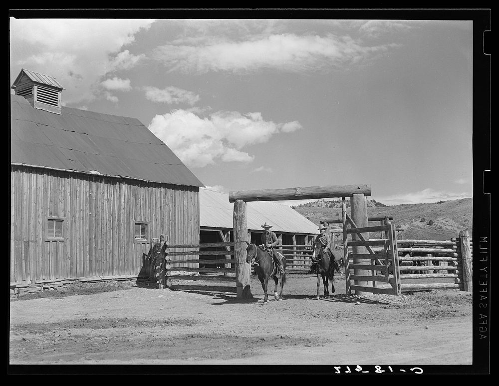 Ranchers riding through corral gate. Quarter Circle 'U' Ranch, Montana. Sourced from the Library of Congress.