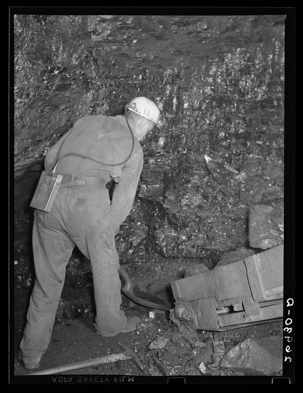 In pitcar loading, a man is required to shovel coal into the conveyer. Old Ben number eight. West Frankfort, Illinois (see…