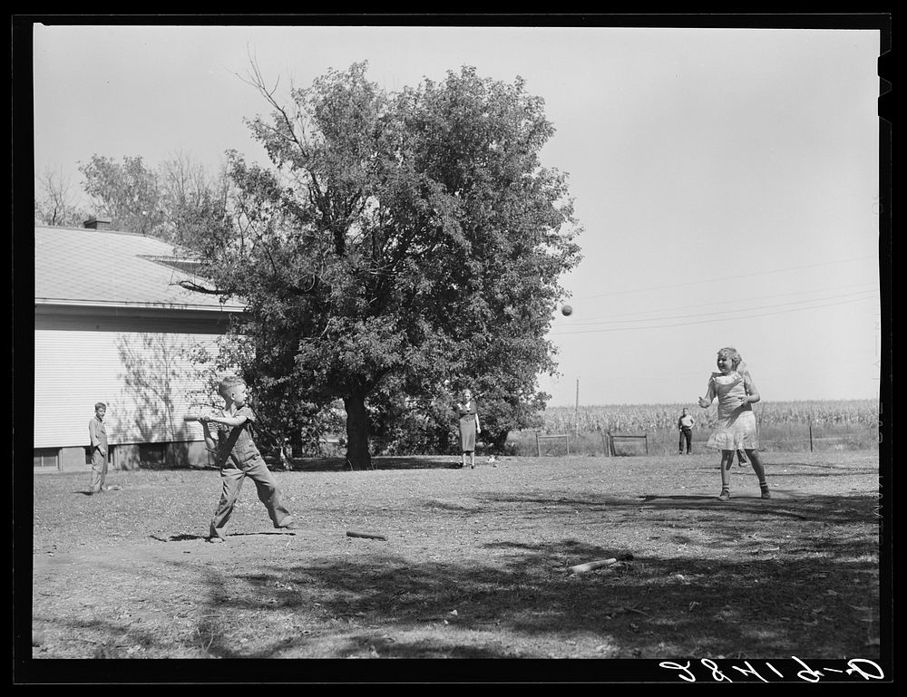 Teacher supervises ball game during recess period. Grundy County, Iowa. Sourced from the Library of Congress.