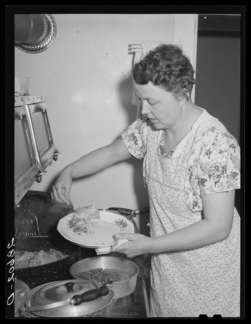 Mrs. Thomas Beede serving dinner resettlement home. Western Slope Farms, Colorado. Sourced from the Library of Congress.