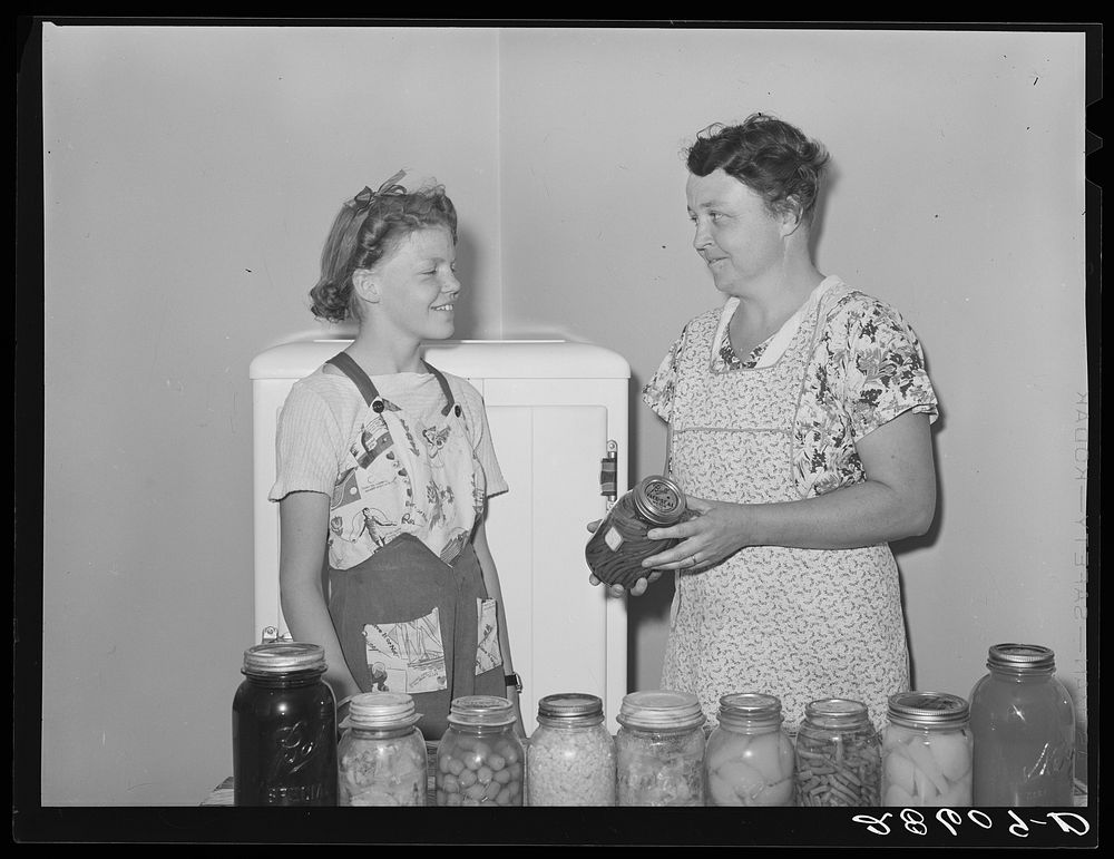Mrs. Thomas Beede and daughter Margaret with preserved food. Western Slope Farms, Colorado. Sourced from the Library of…