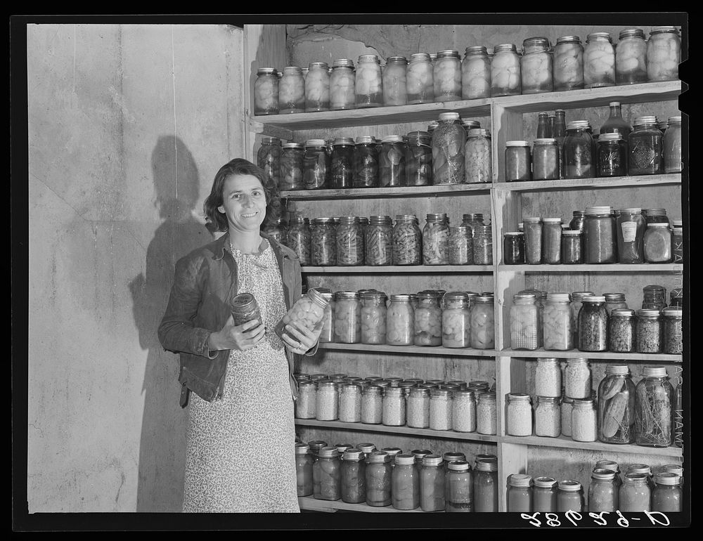 Mrs. H.H. Poland, wife of FSA (Farm Security Administration) rehabilitation client, with preserved food. Mesa County…