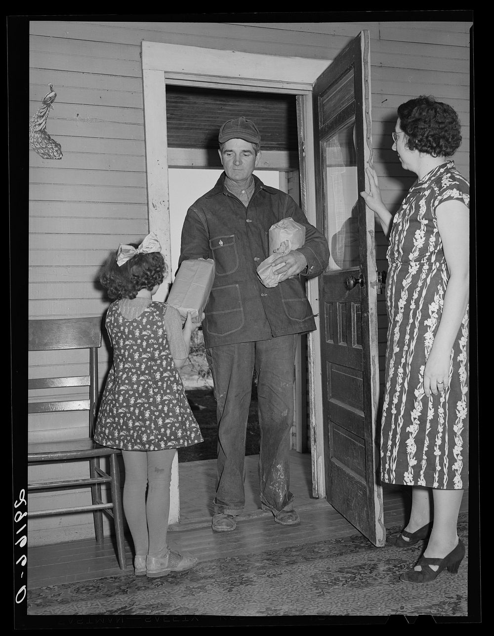 Farmer arrives home after shopping in town. Greene County, Missouri. Sourced from the Library of Congress.