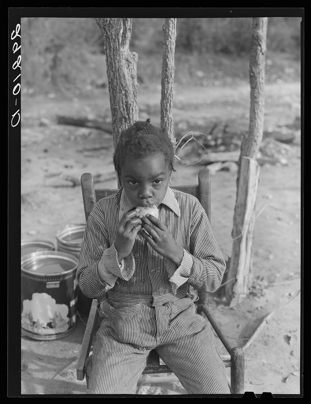 Evicted sharecropper's child eating orange from F.S.C.C supply. Butler County, Missouri. Sourced from the Library of…