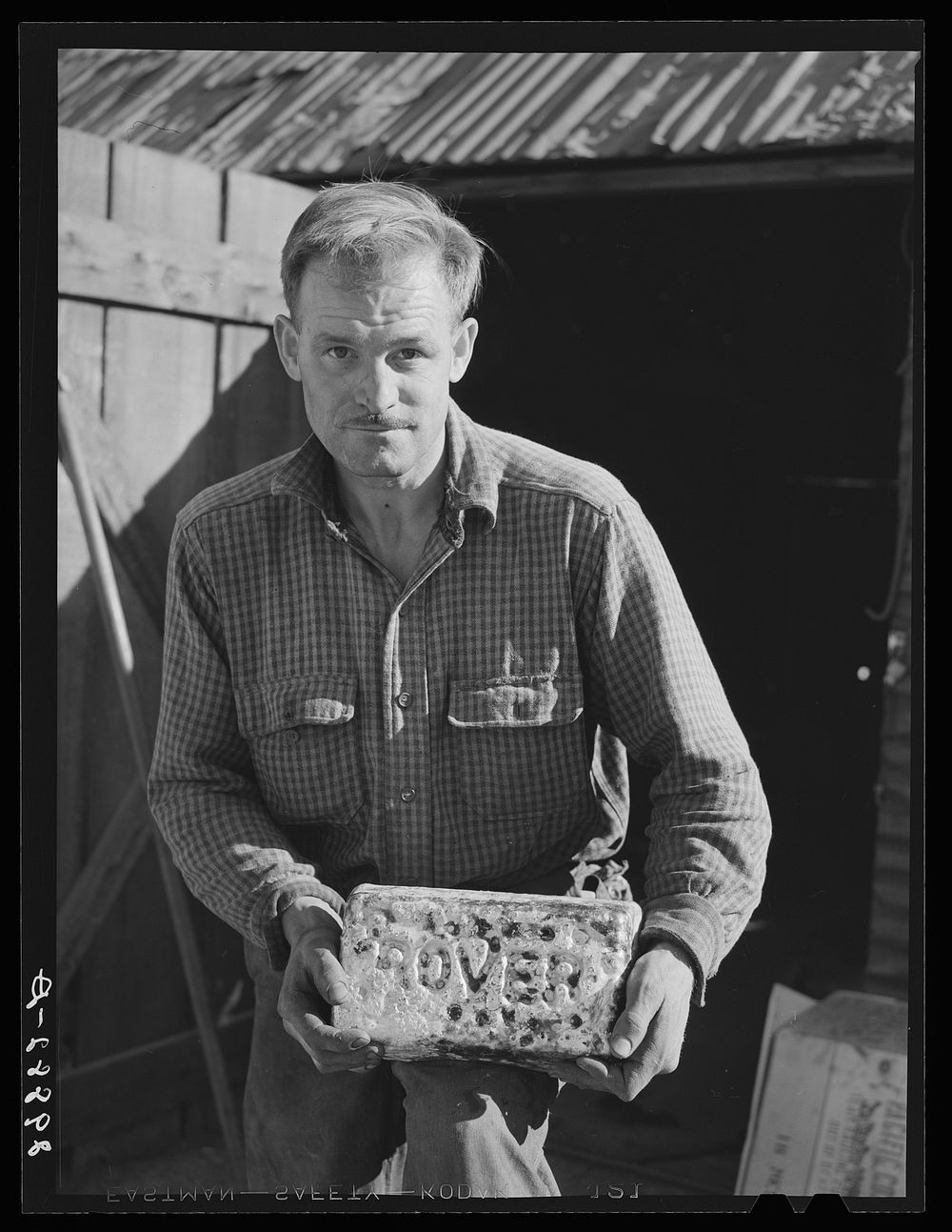 Miner with gold and silver brick worth about 2,000 dollars. El Dorado Canyon, Clark County, Nevada. Sourced from the Library…