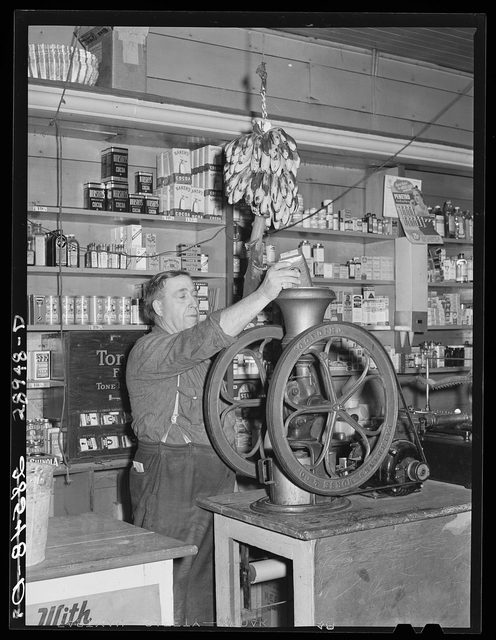 Grinding coffee. General store, Lamoille, Iowa. Sourced from the Library of Congress.