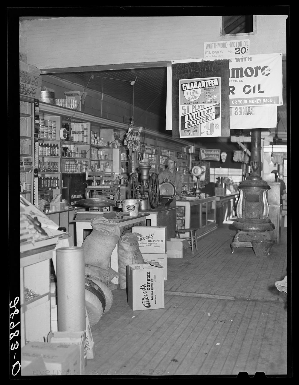 General store sells everything from batteries to bananas. Lamoille, Iowa. Sourced from the Library of Congress.