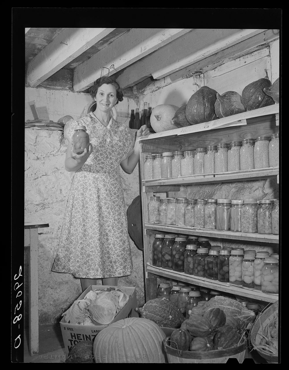 Rehabilitation client's wife with part of the winter's food supply raised in her own garden. Black Hawk County, Iowa.…