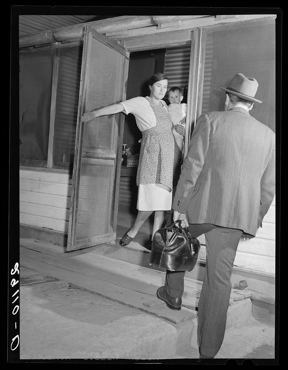 Wife of a rehabilitation client greets a physician who cooperates with the FSA (Farm Security Administration) medical health…