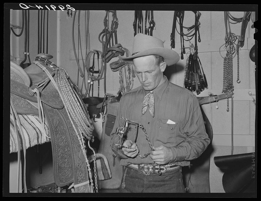 Cowhand examining bit. Capriola Saddlery, Elko, Nevada. Sourced from the Library of Congress.