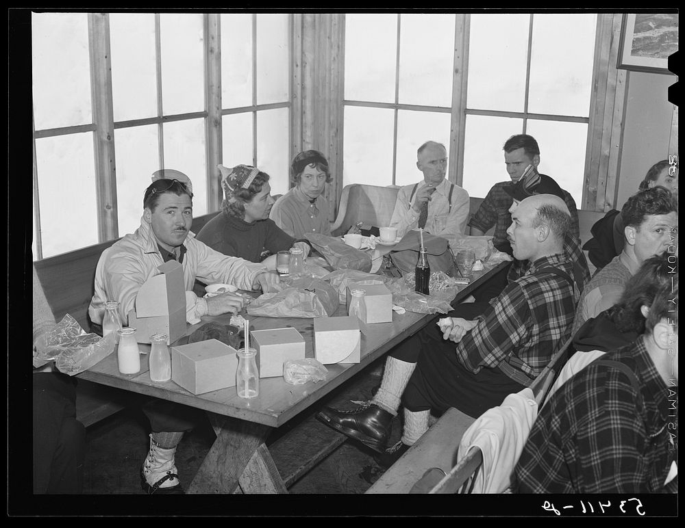 Skiers eating lunch in tollhouse at foot of Mount Mansfield. Smugglers Notch. Near Stowe, Vermont. Sourced from the Library…