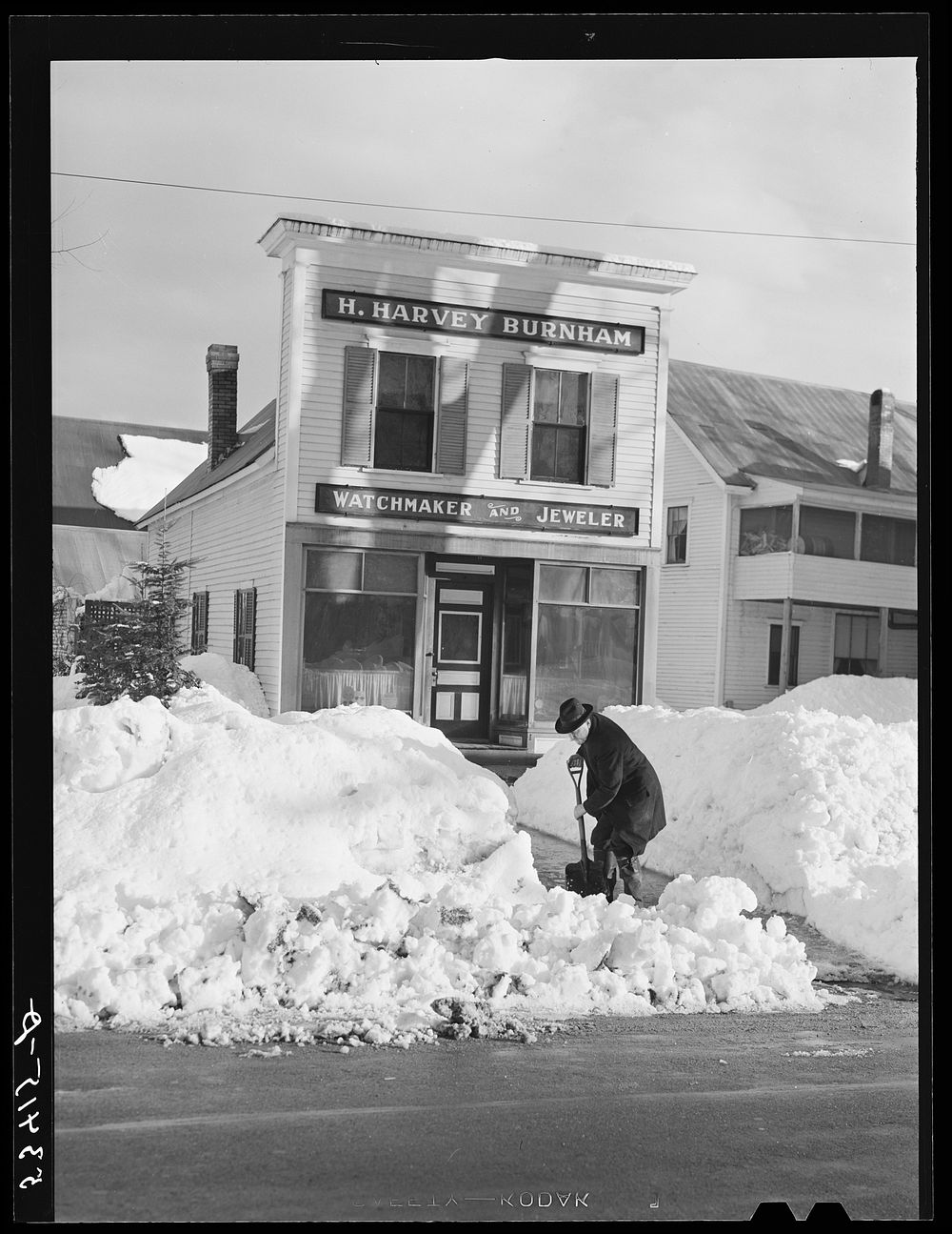 Shopkeepers in Fryeburg, Maine must shovel paths and sidewalks too frequently in the winter. Sourced from the Library of…