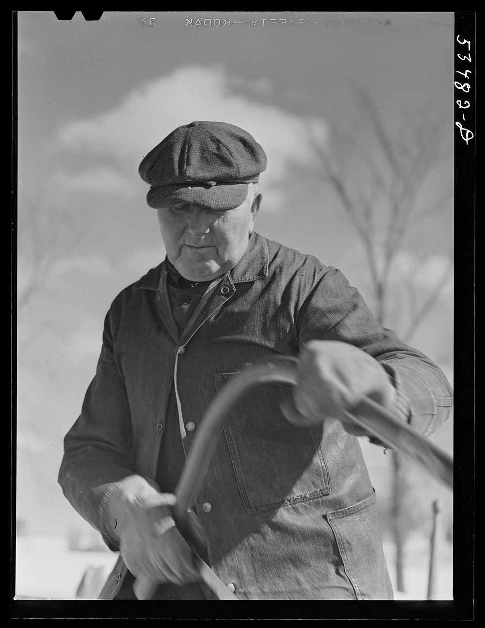 [Untitled photo, possibly related to: Farmer sawing wood for winter fuel. Near Littleton, New Hampshire]. Sourced from the…