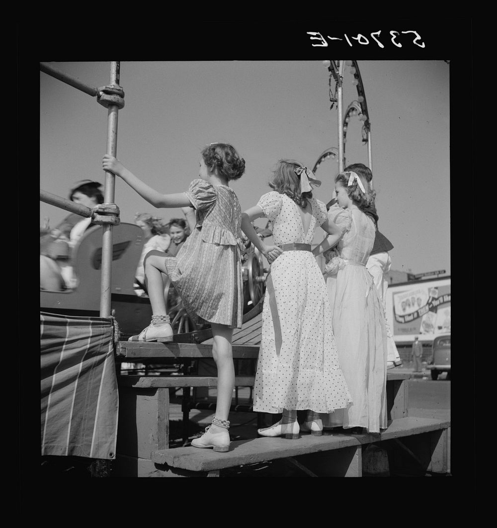 Children enjoying the midway after a parade at the Memphis cotton carnival. Memphis, Tennessee. Sourced from the Library of…