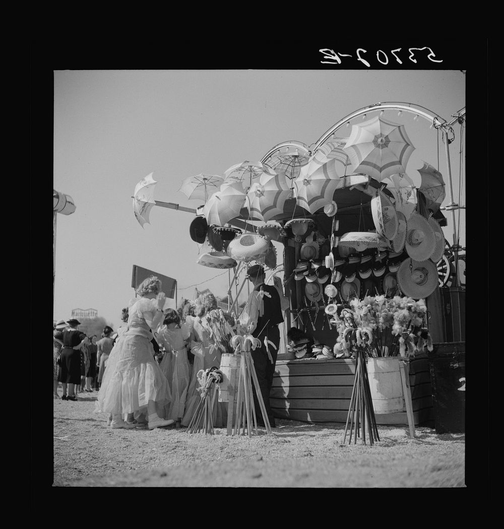 Children enjoying the midway after a parade at the Memphis cotton carnival. Memphis, Tennessee. Sourced from the Library of…