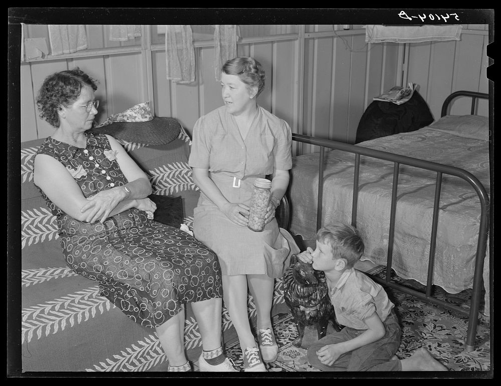 Home management supervisor Mrs. Merrin discusses the canning program with one of camp members inside her shelter. Osceola…