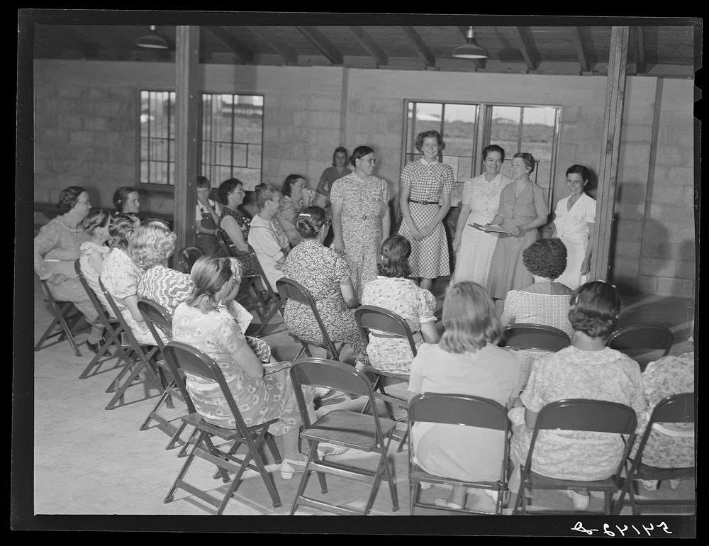 Home management supervisor Mrs. Merrin has a women's club group discussion and meeting in the assembly building at Osceola…