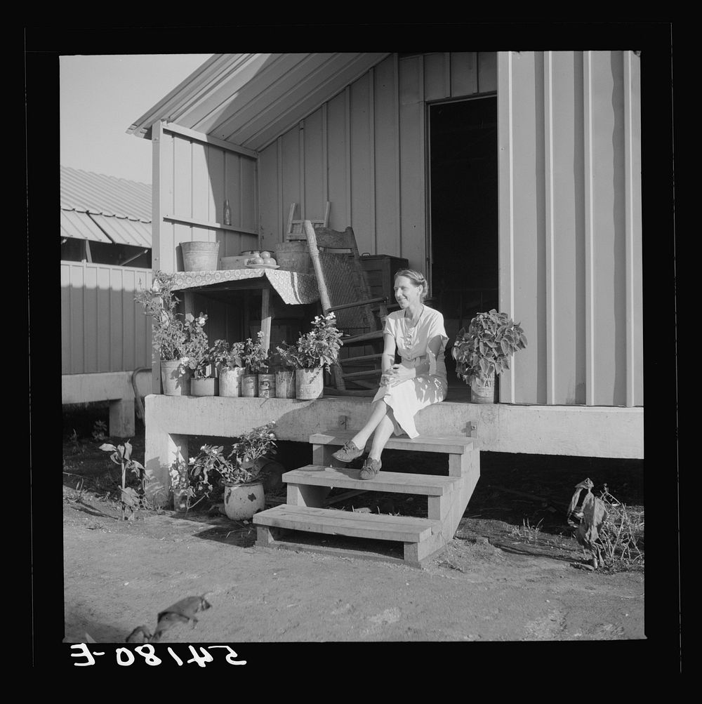 [Untitled photo, possibly related to: Camp member on porch of her shelter at Osceola migratory labor camp. Belle Glade…