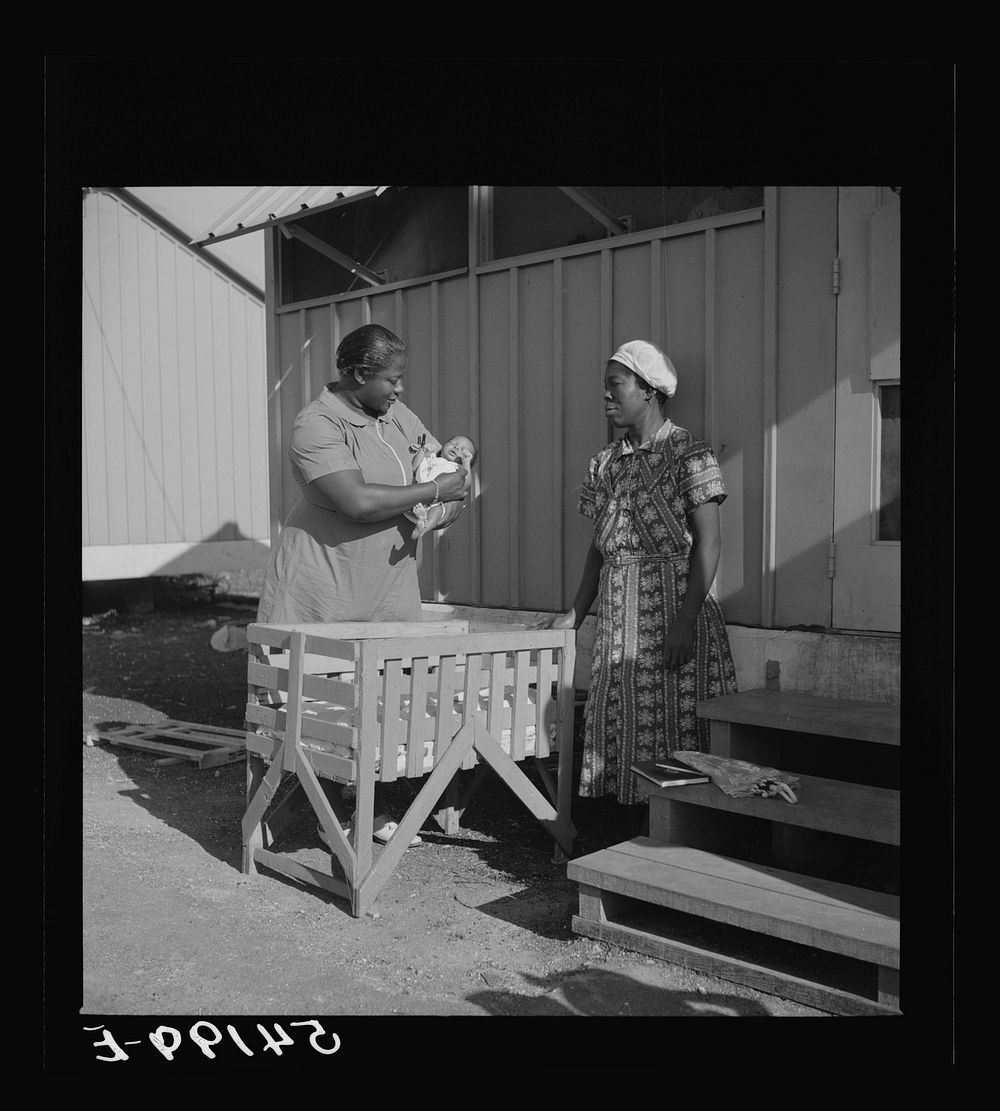 [Untitled photo, possibly related to: The nurse examines one of the camp's first babies. Mother and child are given both…