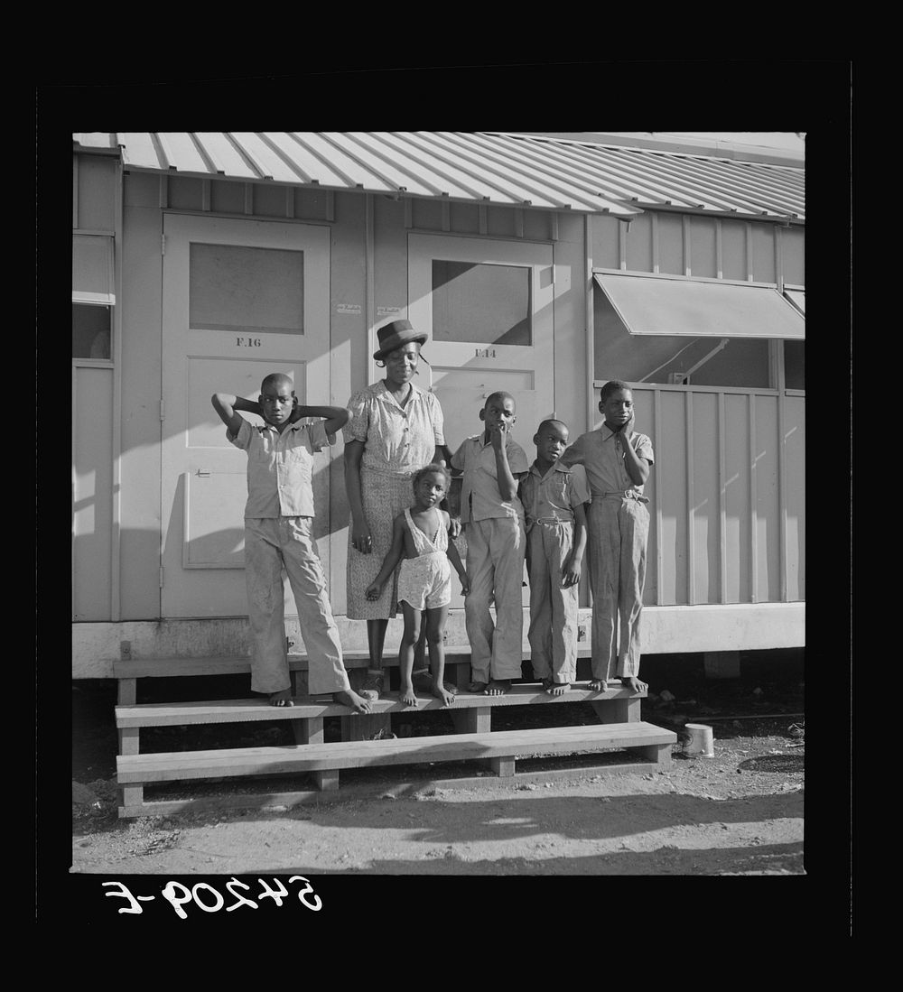[Untitled photo, possibly related to: The Robinson family outside their shelter at Okeechobee migratory labor camp. Belle…