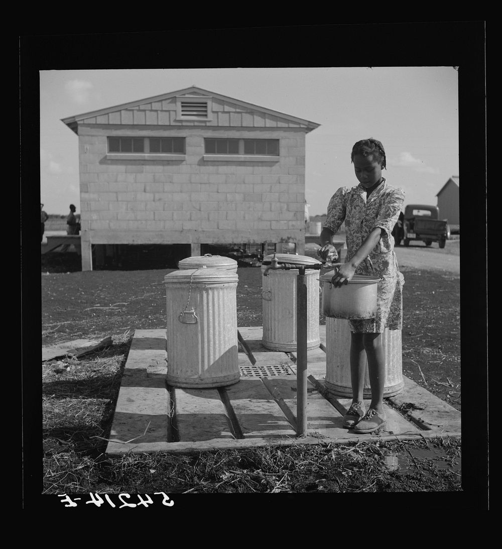 Running water and garbage and refuse disposal are placed at head of each shelter unit division of Okeechobee migratory labor…