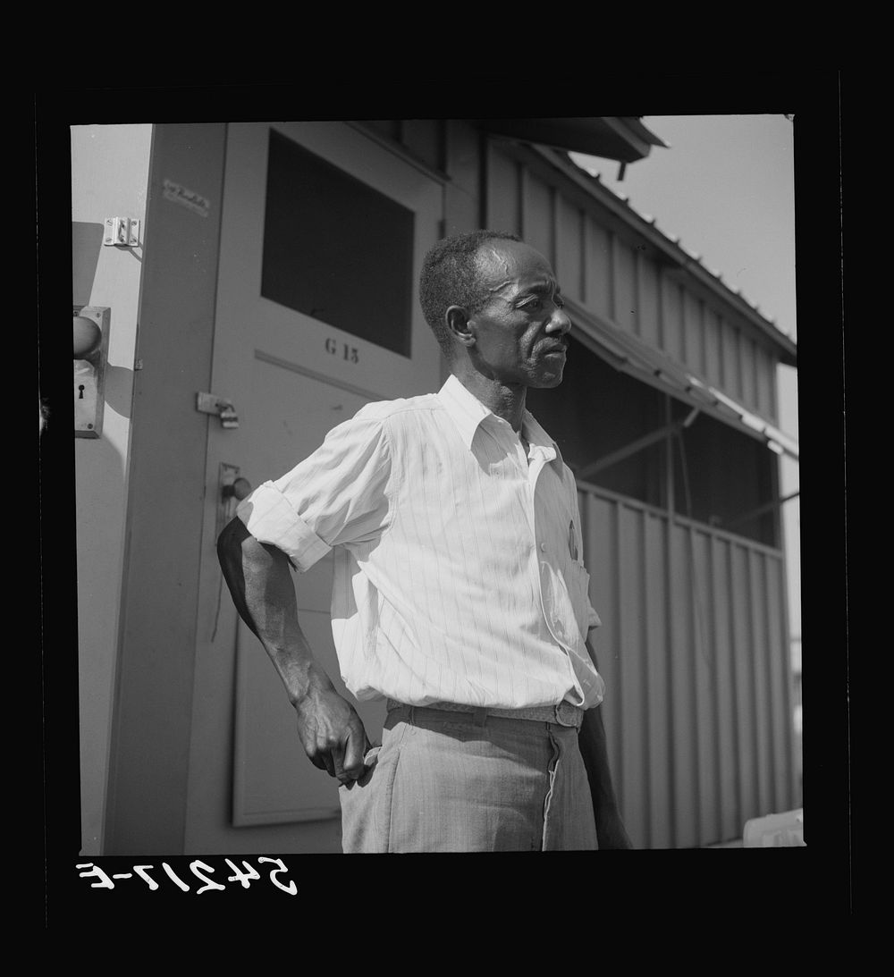 Camp member moving into shelter at Okeechobee migratory labor camp. Belle Glade, Florida. Sourced from the Library of…
