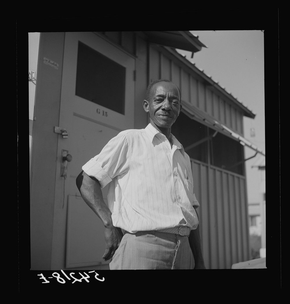 Camp member moving into shelter at Okeechobee migratory labor camp. Belle Glade, Florida. Sourced from the Library of…