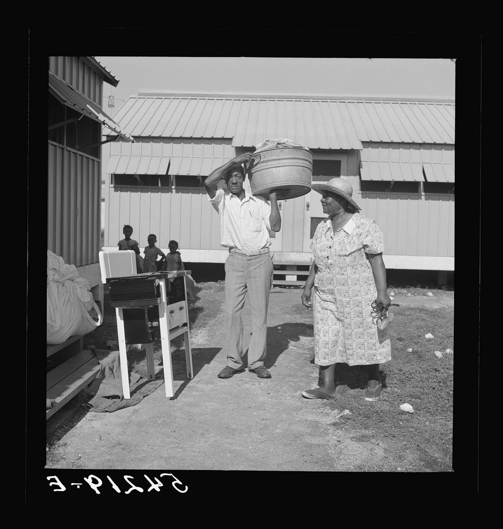Camp members moving into shelter at Okeechobee migratory labor camp. Belle Glade, Florida. Sourced from the Library of…