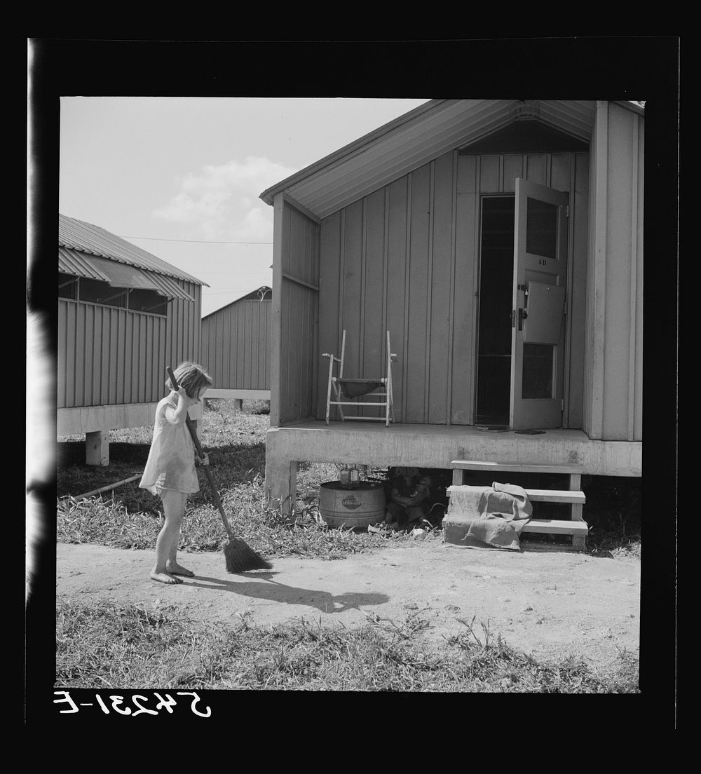 Camp members' children are taking an interest in keeping shelters and grounds clean. Osceola migratory labor camp. Belle…