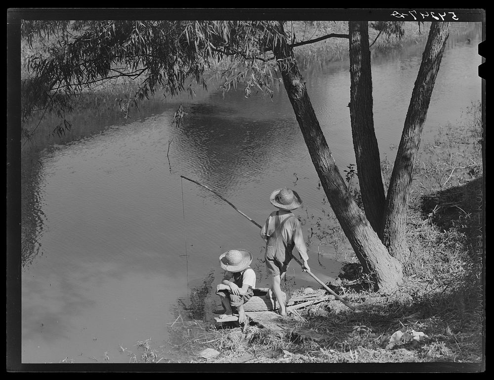 Cajun children fishing in a bayou near the school by Terrebonne Project. Schriever, Louisiana. Sourced from the Library of…