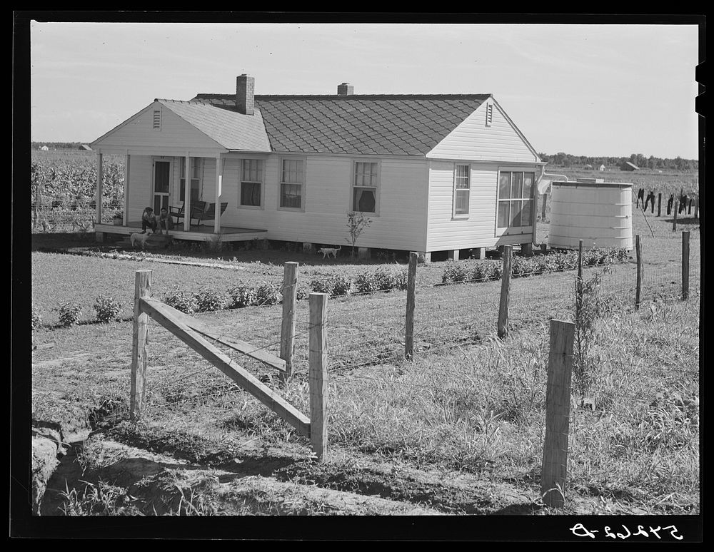 Home with covered cistern for water and fenced garden on Terrebonne Project. Schriever, Louisiana. Sourced from the Library…