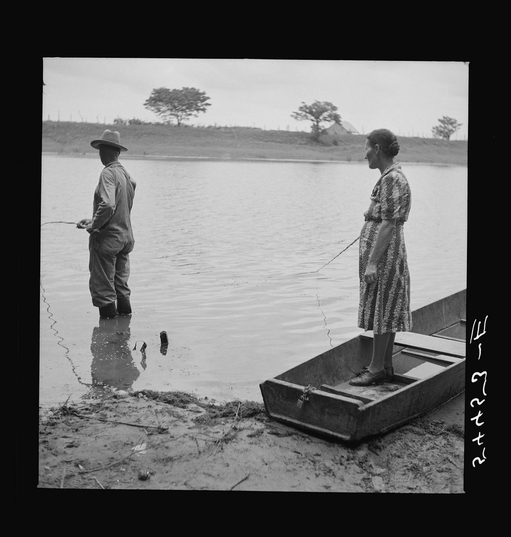 [Untitled photo, possibly related to: Farmer and his wife fishing in Cane River on Fourth of July. Later the whole family…