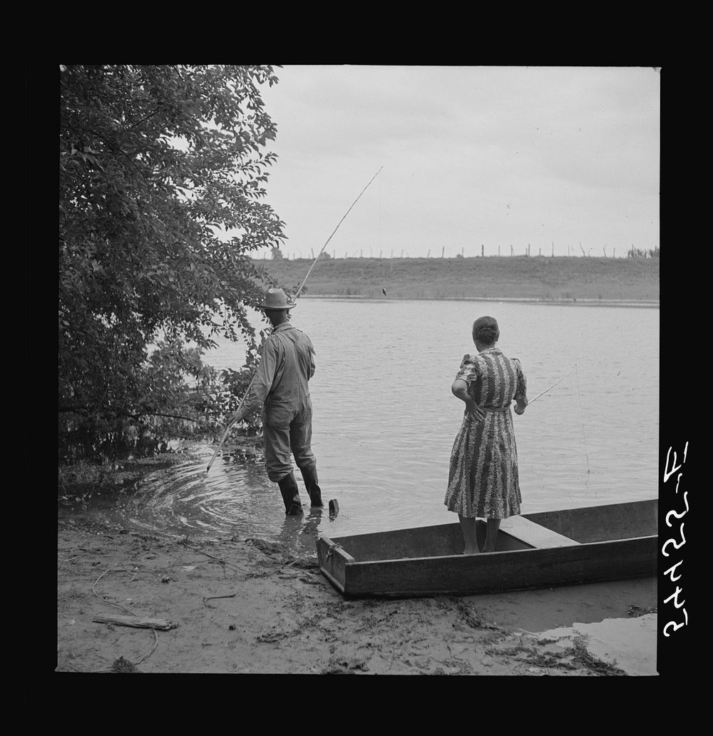 Farmer and his wife fishing in Cane River on Fourth of July. Later the whole family had a fish fry. Near Natchitoches…