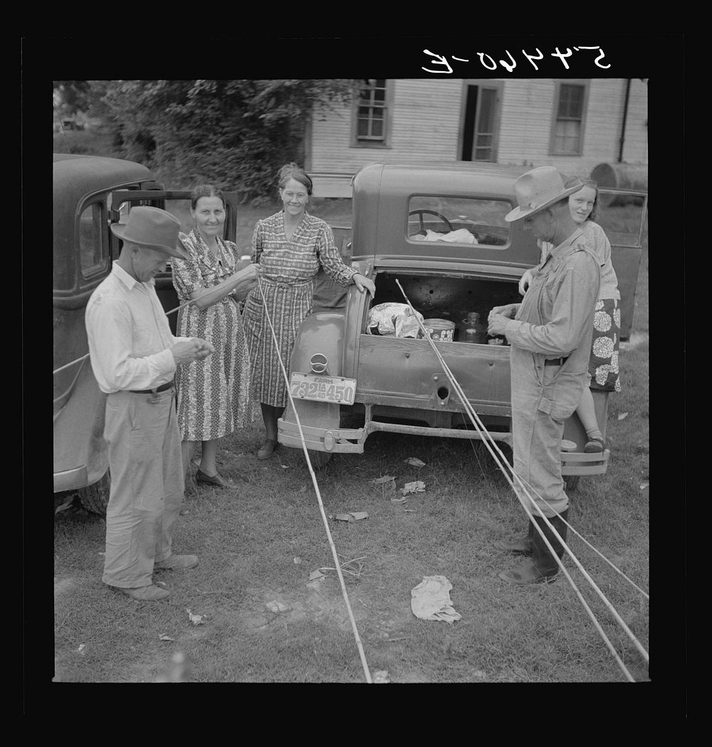 [Untitled photo, possibly related to: Farm family getting out their fishing poles to catch catfish in Cane River, near…