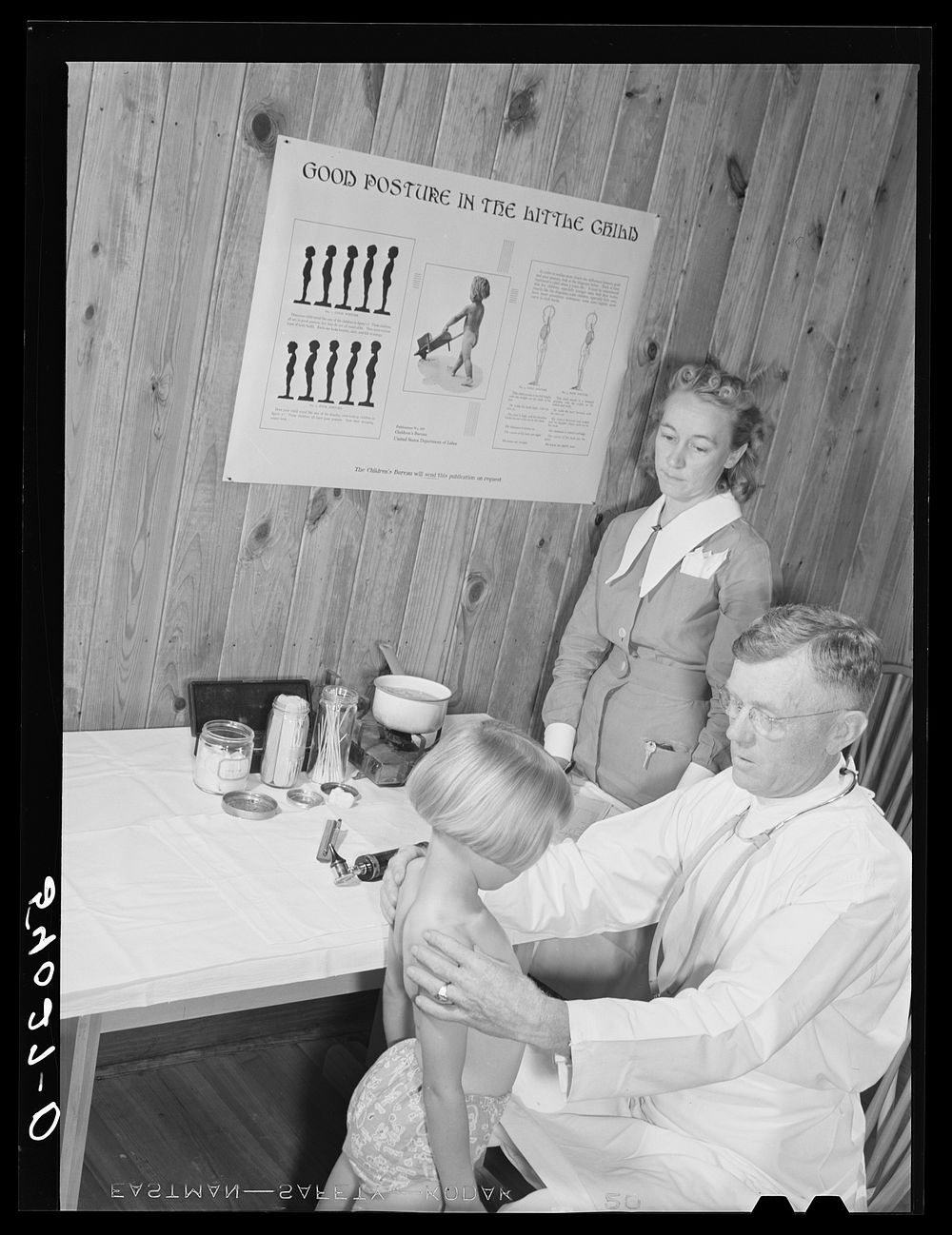 [Untitled photo, possibly related to: Mrs. M.E. Chappell with her daughter, Sybil Lee, being examined by Dr. F.A. Williams…