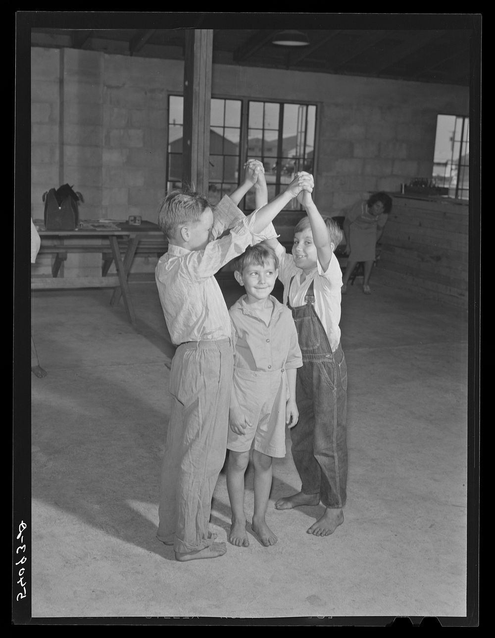 Supervised play hour for younger children in assembly building at Osceola migratory labor camp. Belle Glade, Florida.…