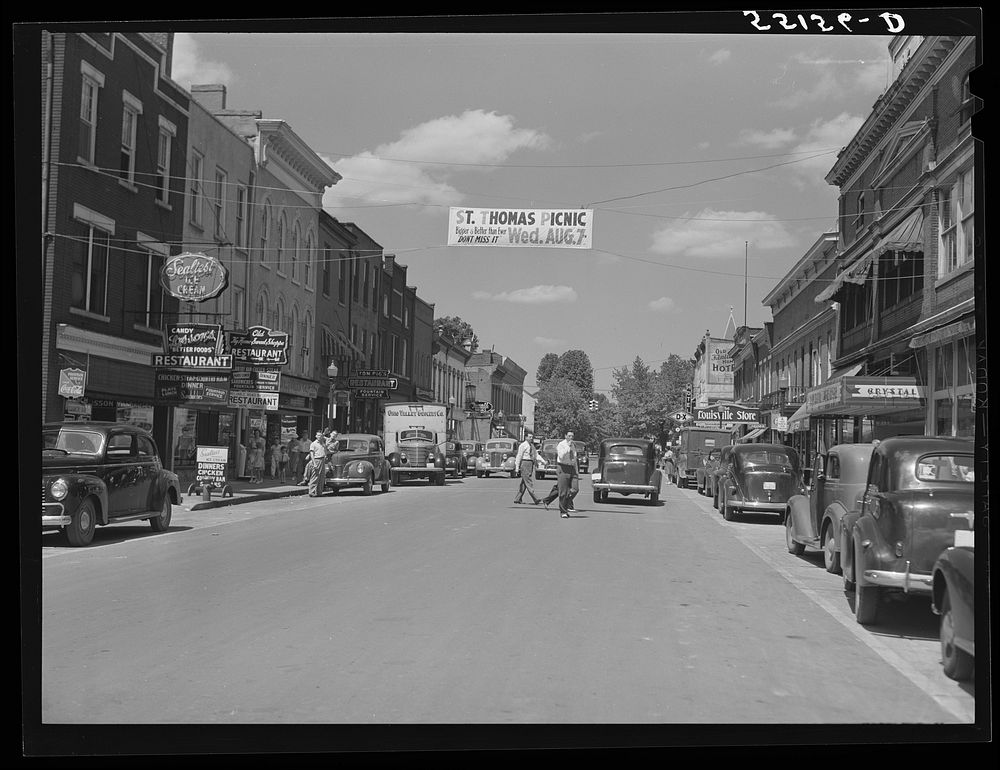 Center of town with banner advertising church picnic. Bardstown, Kentucky. Sourced from the Library of Congress.