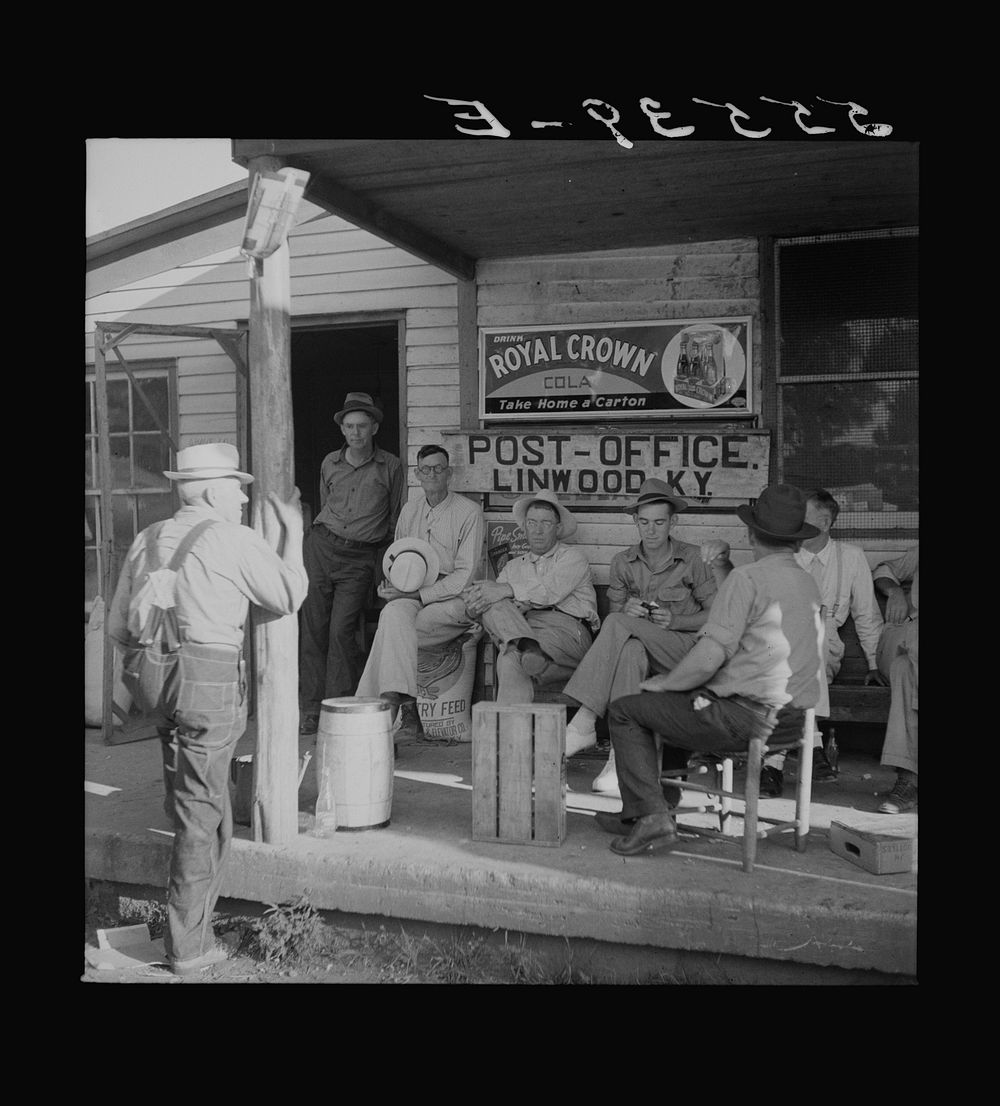 Farmers sitting around in front of the post office on Saturday afternoon. Linwood, Kentucky. Sourced from the Library of…