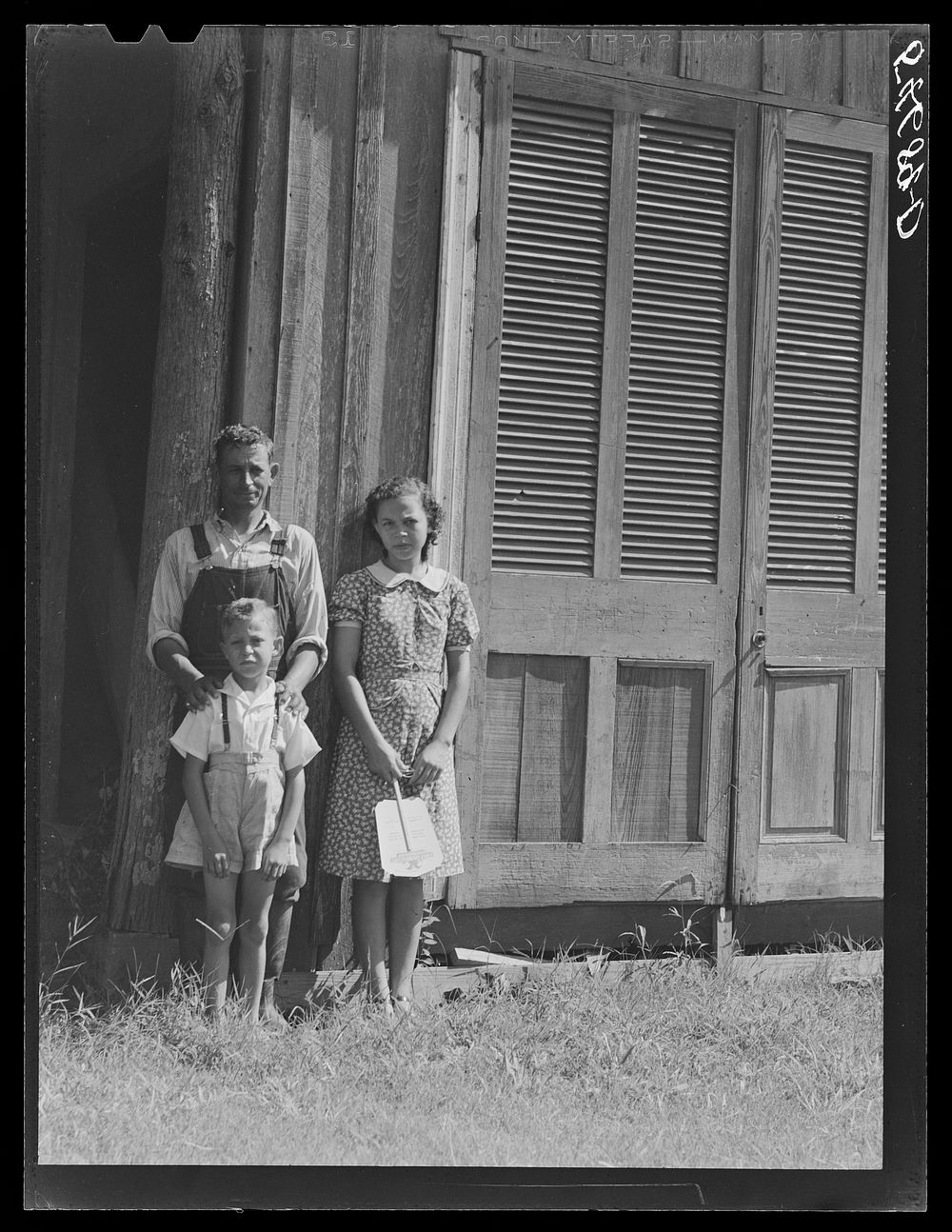 Melrose, Natchitoches, Louisiana. Mulatto servant with two of his children in front of home originally built by mulattoes.…