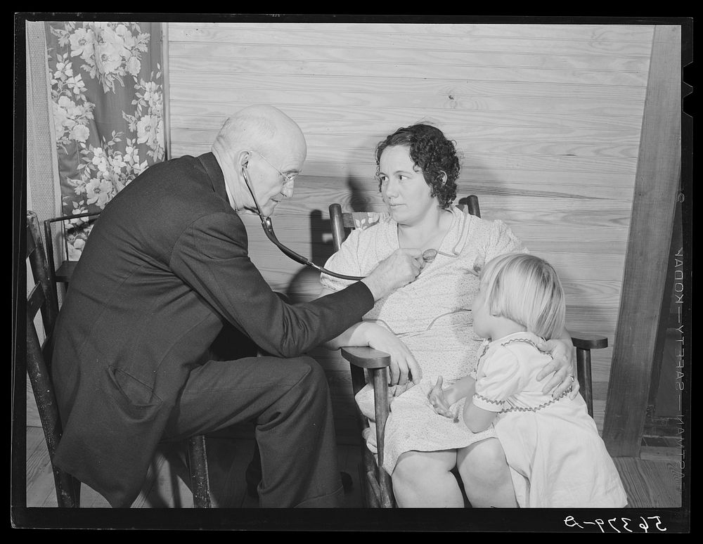Dr. S.A. Malloy examining Mrs. William H. Willis and her family. Mr. Willis is a FSA (Farm Security Administration)…